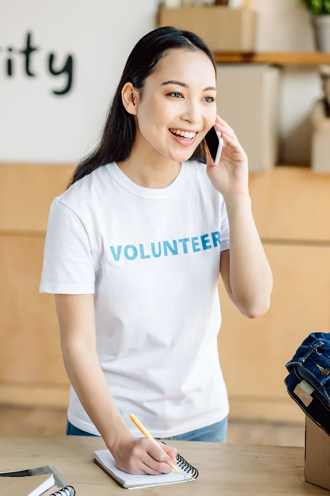 attractive-asian-volunteer-talking-on-smartphone-a-